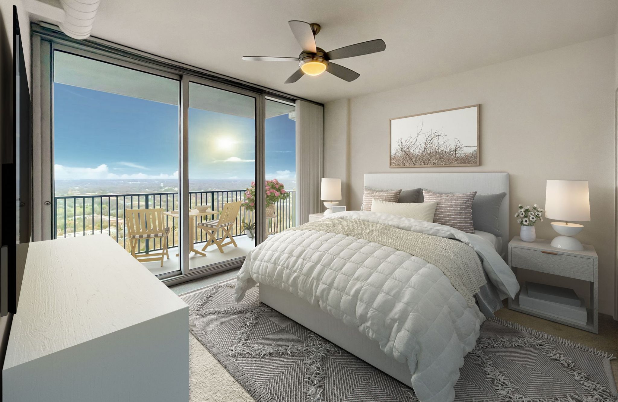 The Vue Charlotte apartment bedroom with ceiling fan, floor-to-ceiling windows with view of the city