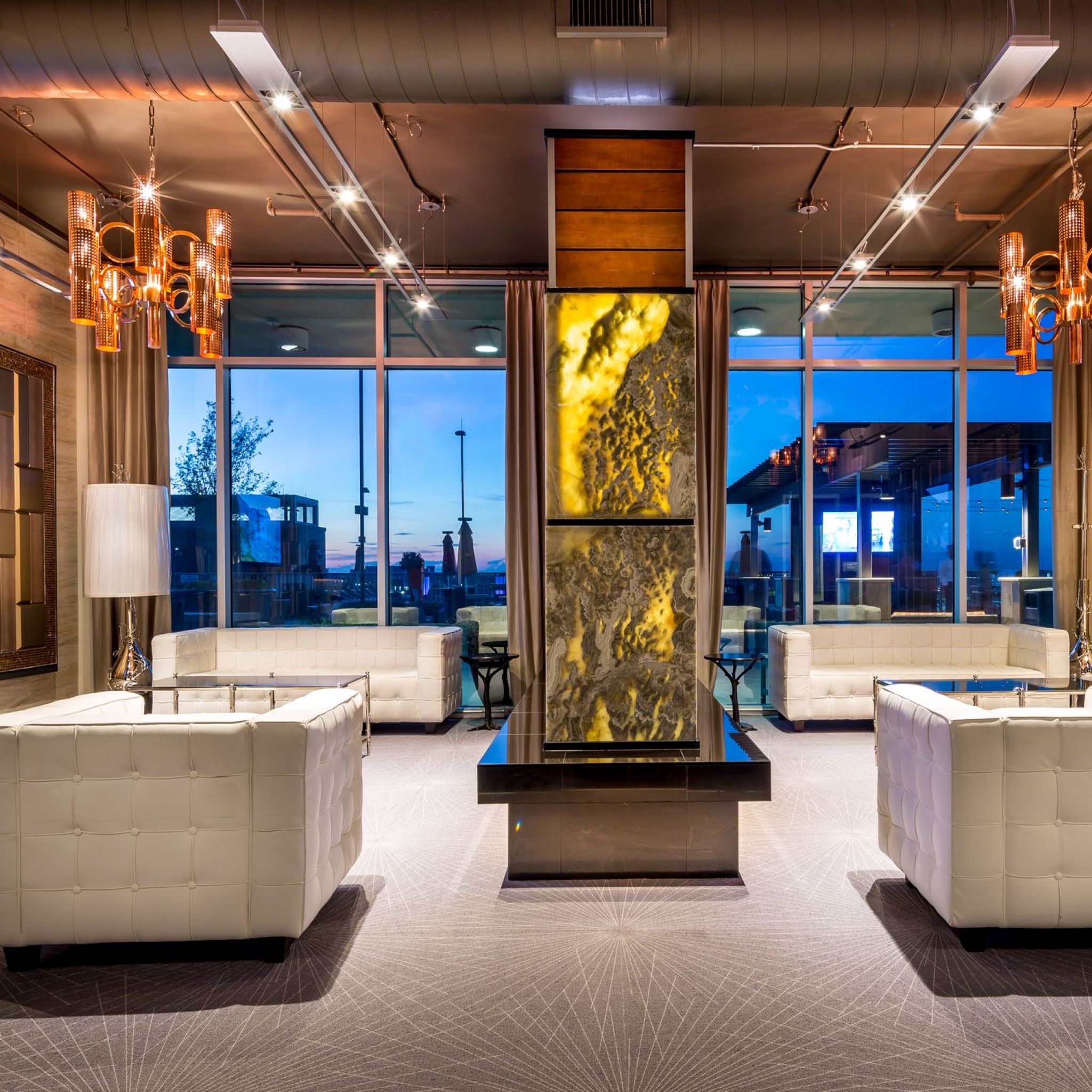 The Vue resident community center and lounge with couches, chandeliers, and beautiful finishes