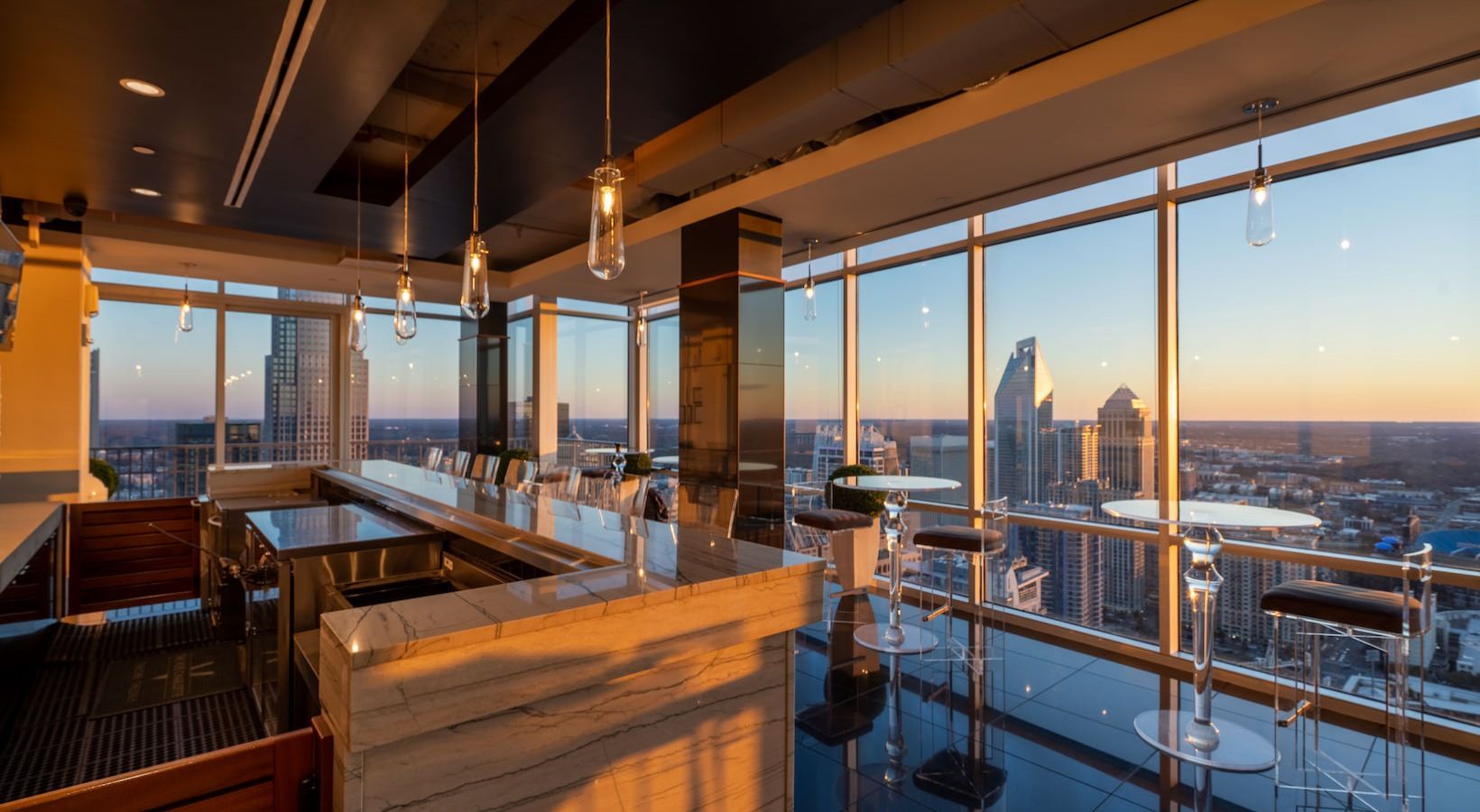Sky Lounge at The VUE Charlotte high rise apartments overlooking the city at dusk